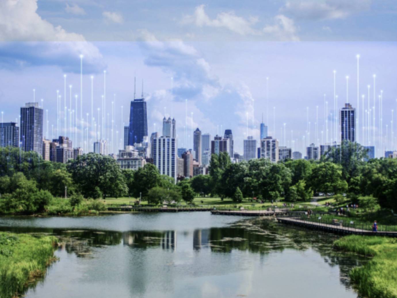 A cityscape surrounded by greenery on the banks of a water body