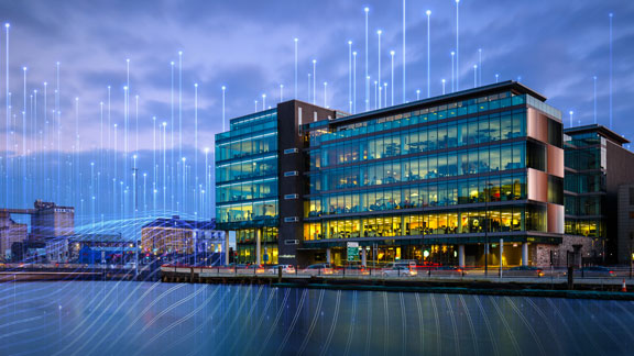 One Albert Quay building lit up at dusk