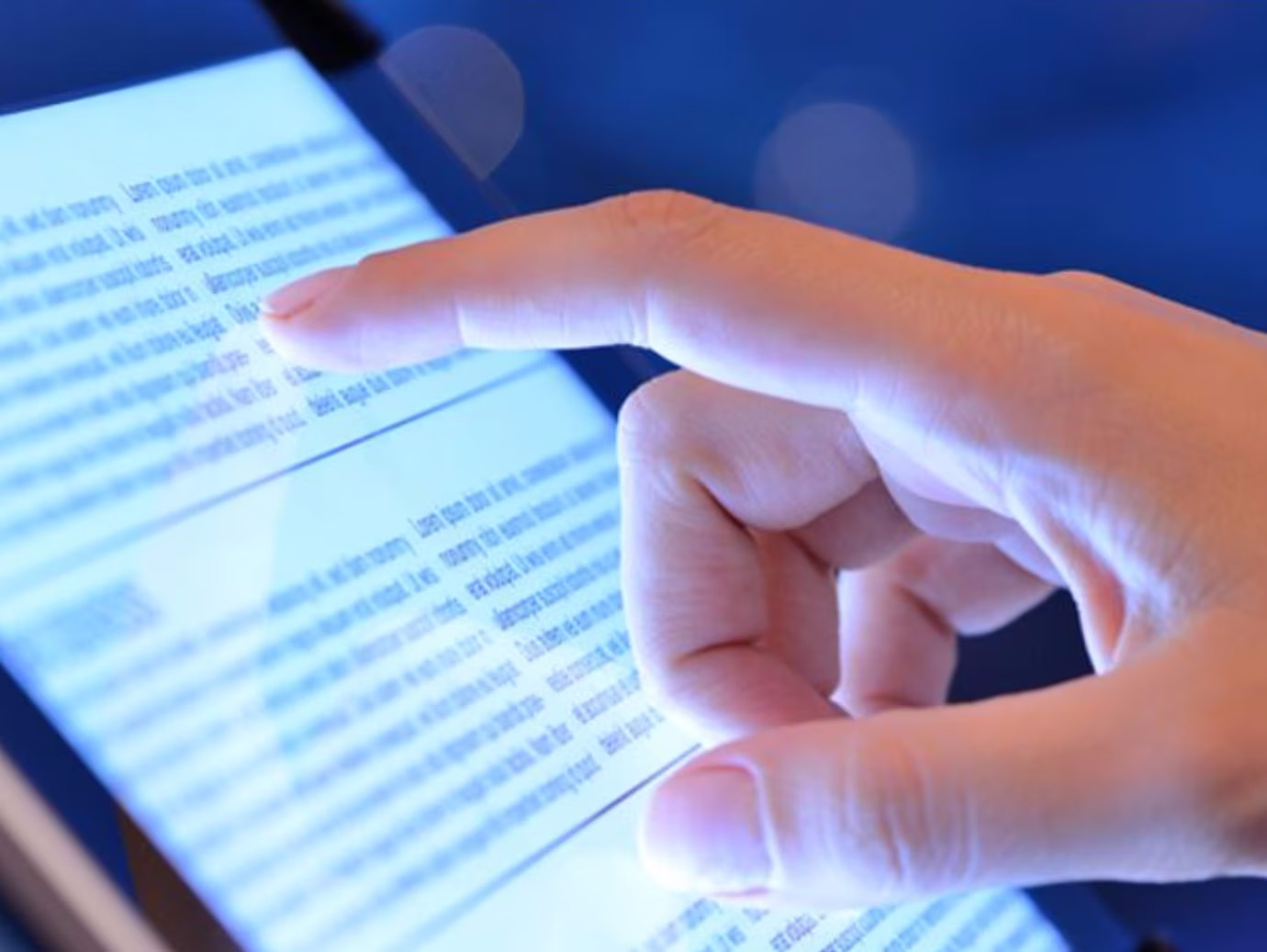 Close up of a hand scrolling a tablet