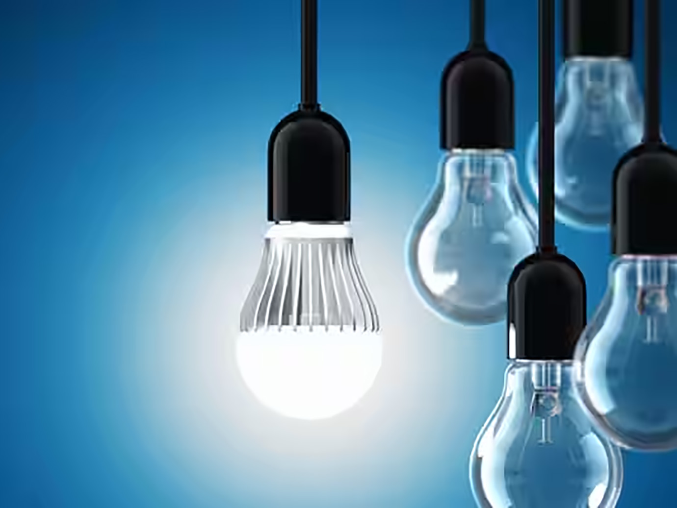 A set of LED bulbs hanging against a blue background, with one of them lit