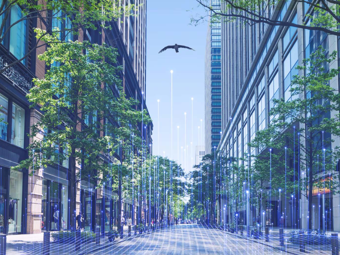 A pathway between two glass buildings, with a bird flying overhead, overlaid with OpenBlue graphics