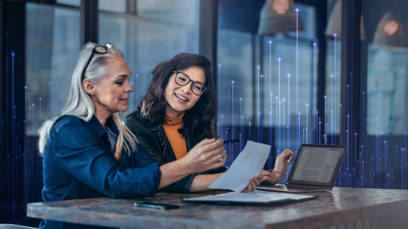 Two women discussing a document at work
